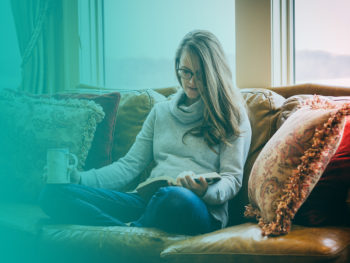 Woman reading on a couch. Learn more about quitting smoking.