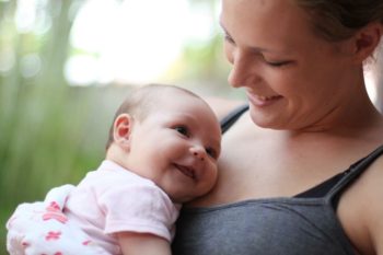 A mother and baby pose and smile. Learn more about vaping and tobacco use in Colorado.