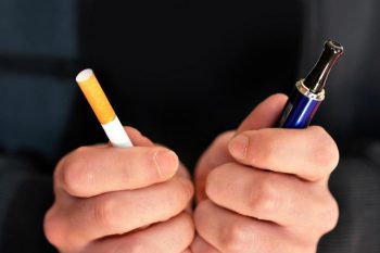 A man using a vape device. Learn more about vaping and the risks.