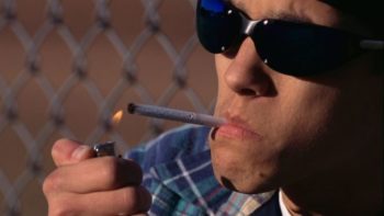 A man lights a cigarette. Learn more about quitting tobacco.