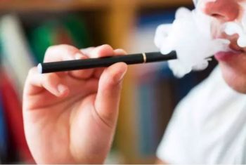 Colorado adult uses a vape pen in this stock image. Learn more about vaping and tobacco use in Colorado.