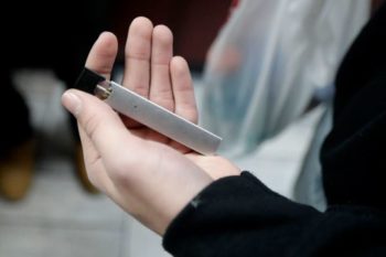 Colorado adult uses a vape pen in this stock image. Learn more about vaping and tobacco use in Colorado.