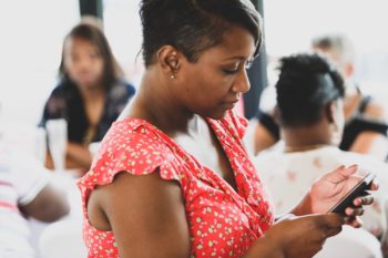 A woman accesses information on her smartphone. Learn more about vaping and tobacco use in Colorado.