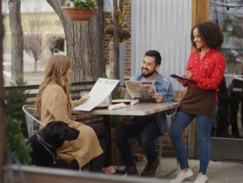 server patrons and dog on restaurant patio