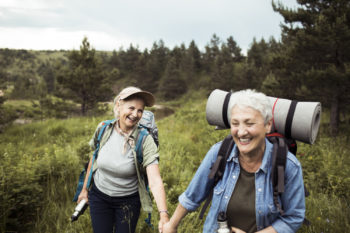 Close up of two senior female friends hiking together
