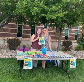 Broomfield staff members collecting devices at a "Hand It In" community event outside of their office.